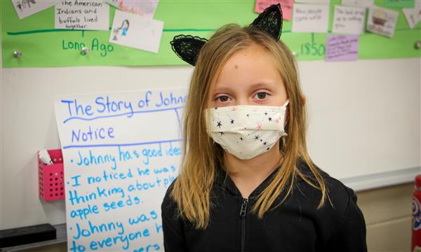 Girl smiles while dressed as a book character